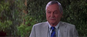 Movie still from “Scream 3” (2000), directed by Wes Craven – An older man wearing a suit and a tie; Close Up shot, Low angle