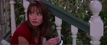 Movie still from “Scream 3” (2000), directed by Wes Craven – A person sitting on a railing; Medium shot, High angle