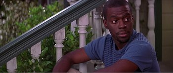 Movie still from “Scream 3” (2000), directed by Wes Craven – A man sitting on the steps of a house; Medium shot, High angle