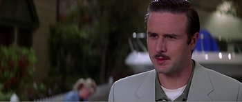 Movie still from “Scream 3” (2000), directed by Wes Craven – A person wearing a suit and a tie; Close Up shot, Over the shoulder angle