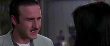Movie still from “Scream 3” (2000), directed by Wes Craven – A man with a mustache talking to a woman; Close Up shot, Over the shoulder angle