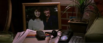 Movie still from “Scream 3” (2000), directed by Wes Craven – A picture of two women sitting next to each other on a desk; Extreme Close Up shot, High angle