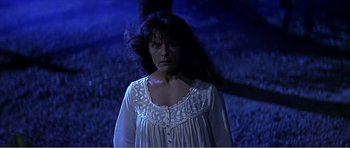 Movie still from “Scream 3” (2000), directed by Wes Craven – A woman in a white dress standing in the dark; Medium shot, Low angle