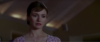 Movie still from “Scream 3” (2000), directed by Wes Craven – A person wearing a necklace; Close Up shot, Over the shoulder angle