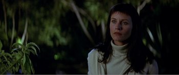 Movie still from “Scream 3” (2000), directed by Wes Craven – A woman in a white sweater is looking at the camera; Close Up shot, Low angle