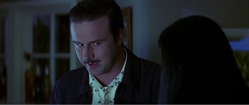 Movie still from “Scream 3” (2000), directed by Wes Craven – A man with a mustache is looking at a woman; Close Up shot, Over the shoulder angle