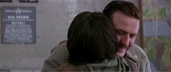 Movie still from “Scream 3” (2000), directed by Wes Craven – A man hugging another man with his arms around him; Close Up shot, Over the shoulder angle