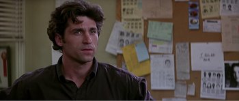 Movie still from “Scream 3” (2000), directed by Wes Craven – A man that is sitting in front of some papers; Close Up shot, Over the shoulder angle