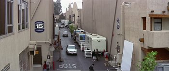 Movie still from “Scream 3” (2000), directed by Wes Craven – A street with many vehicles parked on the side of the road; Extreme Wide shot, High angle