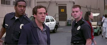 Movie still from “Scream 3” (2000), directed by Wes Craven – Two men standing next to each other in front of a building; Medium shot, Over the shoulder angle