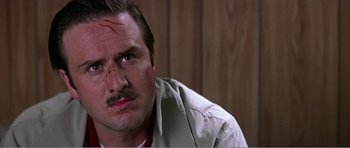 Movie still from “Scream 3” (2000), directed by Wes Craven – A person wearing a shirt and tie; Close Up shot, Low angle