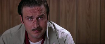 Movie still from “Scream 3” (2000), directed by Wes Craven – A person with a bandage on his head; Close Up shot, Low angle