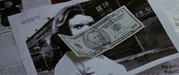 Movie still from “Scream 3” (2000), directed by Wes Craven – A person holding a dollar bill; Extreme Close Up shot, Overhead angle