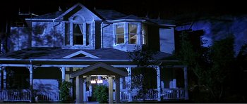 Movie still from “Scream 3” (2000), directed by Wes Craven – A house that has been lit up at night time; Wide shot, Low angle