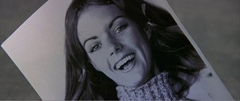 Movie still from “Scream 3” (2000), directed by Wes Craven – A woman smiling for the camera; Extreme Close Up shot, Overhead angle