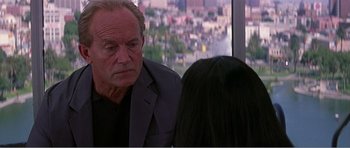 Movie still from “Scream 3” (2000), directed by Wes Craven – An older man and a young woman in front of a window; Close Up shot, Over the shoulder angle