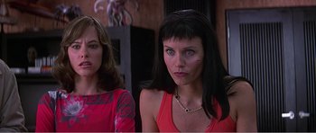 Movie still from “Scream 3” (2000), directed by Wes Craven – Two women are standing next to each other in a room; Close Up shot, Low angle
