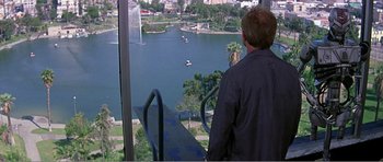 Movie still from “Scream 3” (2000), directed by Wes Craven – A man standing on top of an elevator looking out over a lake; Wide shot, High angle