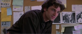 Movie still from “Scream 3” (2000), directed by Wes Craven – A person wearing a black shirt; Close Up shot, Over the shoulder angle