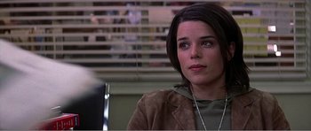 Movie still from “Scream 3” (2000), directed by Wes Craven – A woman sitting in front of a book shelf; Close Up shot, Over the shoulder angle