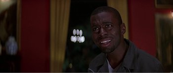 Movie still from “Scream 3” (2000), directed by Wes Craven – A man's face in a dark room; Close Up shot, Low angle