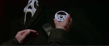 Movie still from “Scream 3” (2000), directed by Wes Craven – A person holding an object in their hand; Extreme Close Up shot, Overhead angle