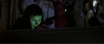 Movie still from “Scream 3” (2000), directed by Wes Craven – A woman looking at her cell phone in the dark; Close Up shot, Low angle