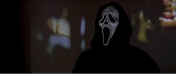 Movie still from “Scream 3” (2000), directed by Wes Craven – A person wearing a mask and a black robe in a room; Close Up shot, Low angle