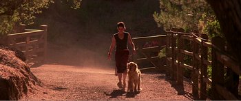 Movie still from “Scream 3” (2000), directed by Wes Craven – A woman walking a dog down a dirt road; Wide shot, Low angle