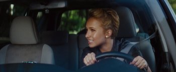 Movie still from “Scream 4” (2011), directed by Wes Craven – A woman sitting in the driver's seat of a car; Close Up shot, Over the shoulder angle