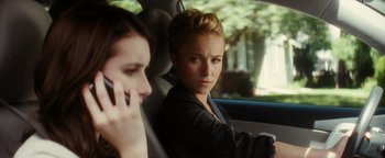 Movie still from “Scream 4” (2011), directed by Wes Craven – A woman sitting in the back seat of a car while talking on the phone; Close Up shot, Over the shoulder angle