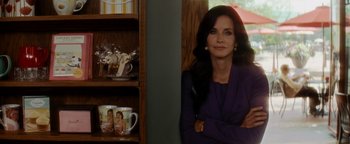Movie still from “Scream 4” (2011), directed by Wes Craven – A woman sitting in front of a wooden shelf; Medium shot, Over the shoulder angle