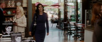 Movie still from “Scream 4” (2011), directed by Wes Craven – A woman in a black dress walking in front of a restaurant; Medium shot, Over the shoulder angle