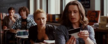 Movie still from “Scream 4” (2011), directed by Wes Craven – A woman and a man sitting next to each other at a table; Medium shot, Over the shoulder angle