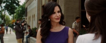 Movie still from “Scream 4” (2011), directed by Wes Craven – A woman with long black hair wearing a purple dress; Close Up shot, Over the shoulder angle