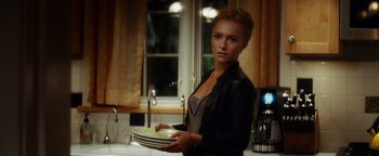 Movie still from “Scream 4” (2011), directed by Wes Craven – A beautiful young woman holding a stack of plates; Medium shot, Over the shoulder angle