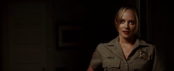 Movie still from “Scream 4” (2011), directed by Wes Craven – A woman in a uniform standing in front of a wall; Close Up shot, Over the shoulder angle