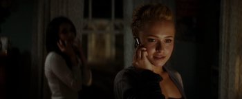 Movie still from “Scream 4” (2011), directed by Wes Craven – A woman talking on a cell phone in the dark; Close Up shot, Over the shoulder angle