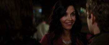 Movie still from “Scream 4” (2011), directed by Wes Craven – A person wearing a necklace smiling; Close Up shot, Over the shoulder angle