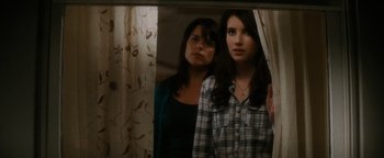 Movie still from “Scream 4” (2011), directed by Wes Craven – Two young women standing in front of a mirror; Medium shot, Over the shoulder angle