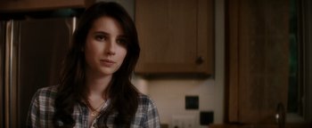 Movie still from “Scream 4” (2011), directed by Wes Craven – A young woman in a plaid shirt in a kitchen; Close Up shot, Over the shoulder angle