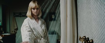 Movie still from “Scream 4” (2011), directed by Wes Craven – A woman standing in front of a mirror in front of a window; Close Up shot, High angle