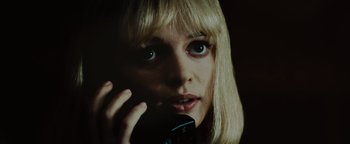 Movie still from “Scream 4” (2011), directed by Wes Craven – A person talking on a cell phone; Close Up shot, Low angle