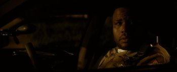 Movie still from “Scream 4” (2011), directed by Wes Craven – A man sitting in the driver's seat of a car at night; Close Up shot, Over the shoulder angle