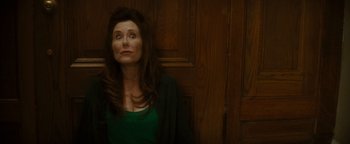 Movie still from “Scream 4” (2011), directed by Wes Craven – A woman standing in front of a wooden wall; Medium shot, Low angle