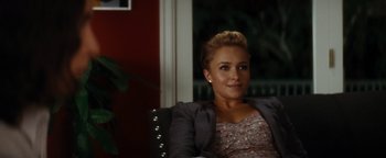 Movie still from “Scream 4” (2011), directed by Wes Craven – A woman sitting in a chair in front of a window; Medium shot, Over the shoulder angle