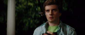 Movie still from “Scream 4” (2011), directed by Wes Craven – A young man wearing headphones while holding a cell phone; Close Up shot, Over the shoulder angle