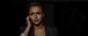 Movie still from “Scream 4” (2011), directed by Wes Craven – A woman is on her cell phone in the dark; Close Up shot, Over the shoulder angle