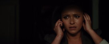 Movie still from “Scream 4” (2011), directed by Wes Craven – A woman holding a cell phone up to her ear; Close Up shot, High angle