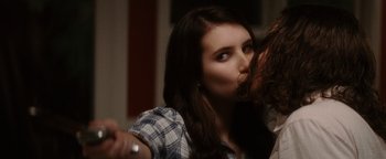 Movie still from “Scream 4” (2011), directed by Wes Craven – A young woman is kissing another young woman's cheek; Close Up shot, Over the shoulder angle